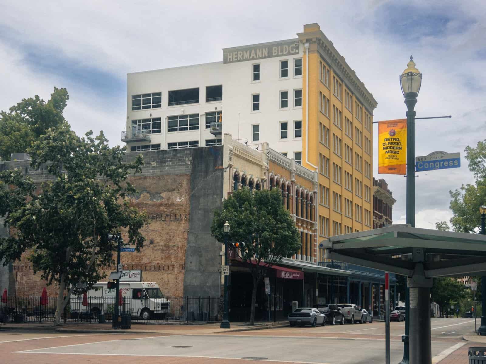 Scenic view of historic buildings in downtown Houston, showcasing urban architecture on a sunny day.