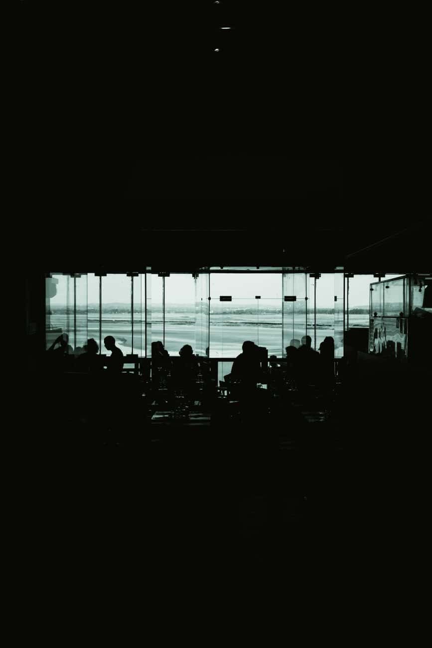 A crowded airport lounge with travelers waiting for seating
