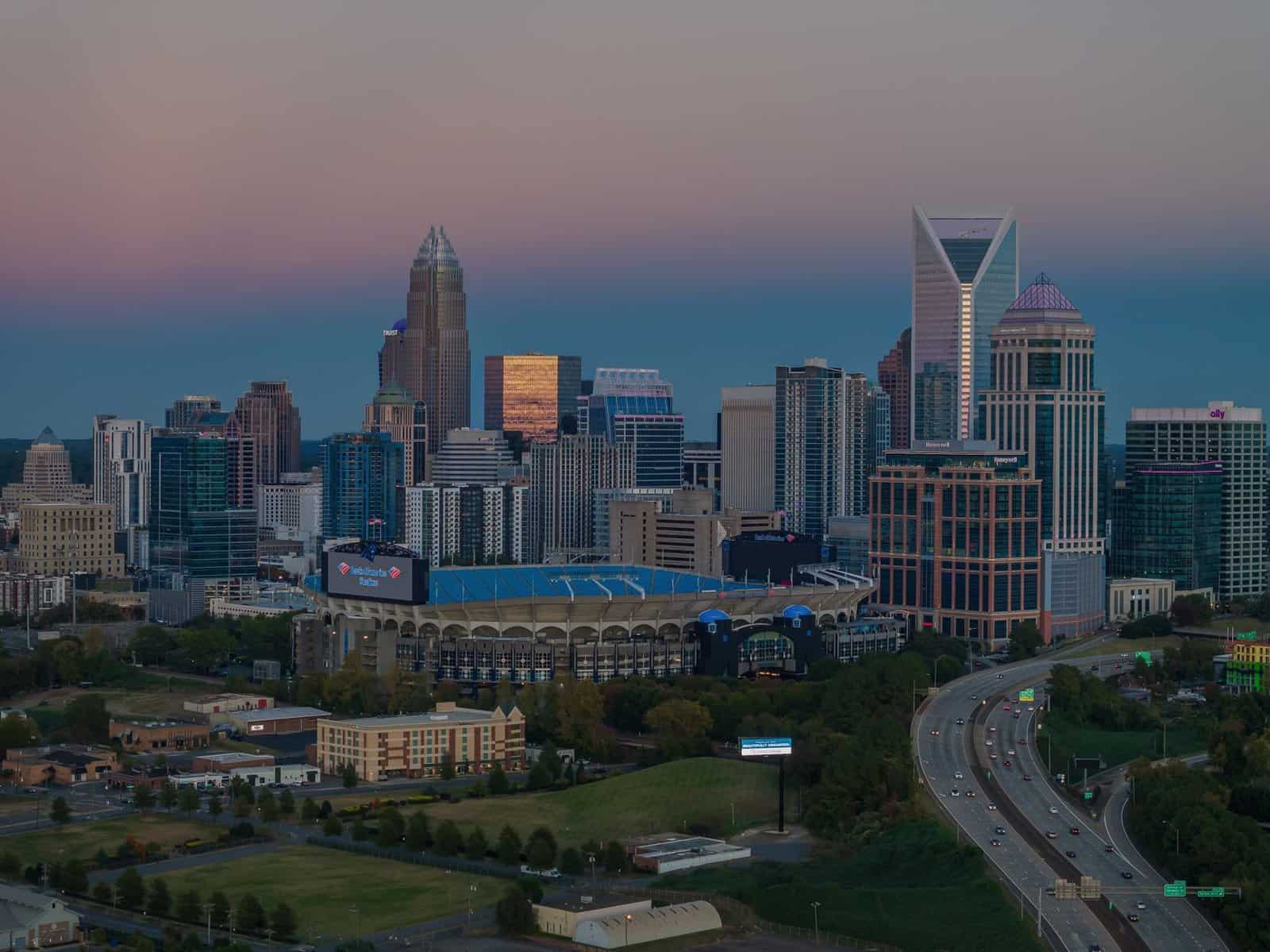 Aerial view of Charlotte skyline and Bank of America Stadium at dusk, North Carolina, USA.