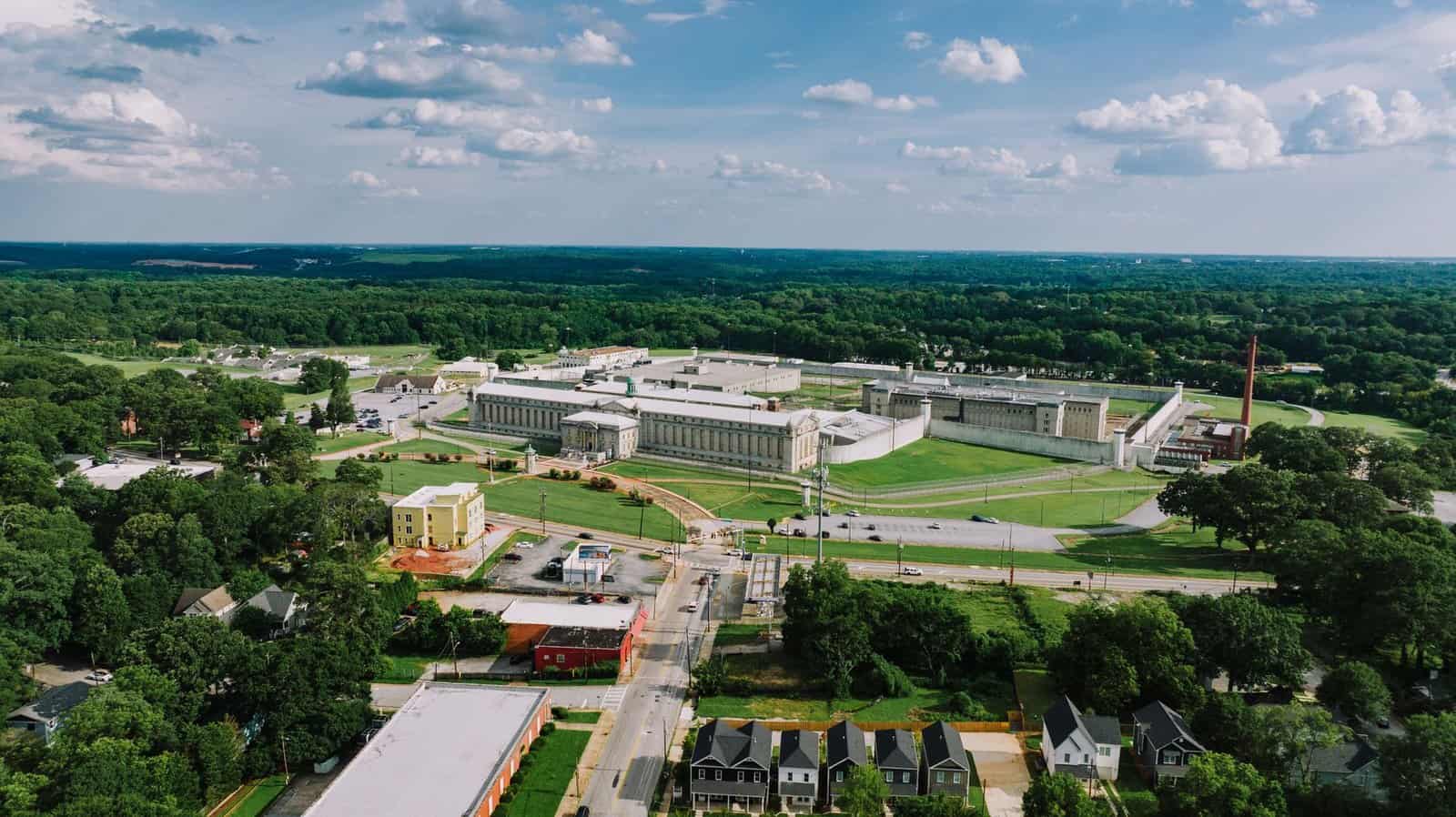 Aerial photo showcasing a sprawling neighborhood and large facility in Atlanta, Georgia on a sunny day.
