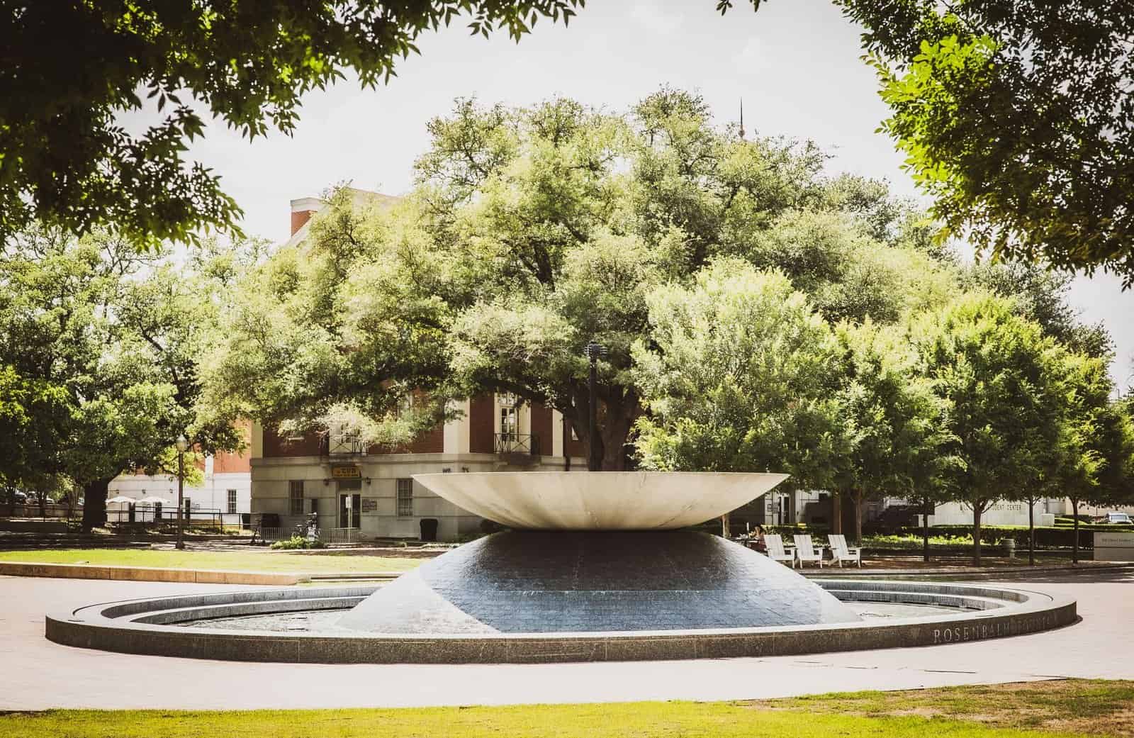 Scenic view of Rosenbalm Fountain surrounded by trees on a sunny day at Baylor University campus, Waco, Texas.