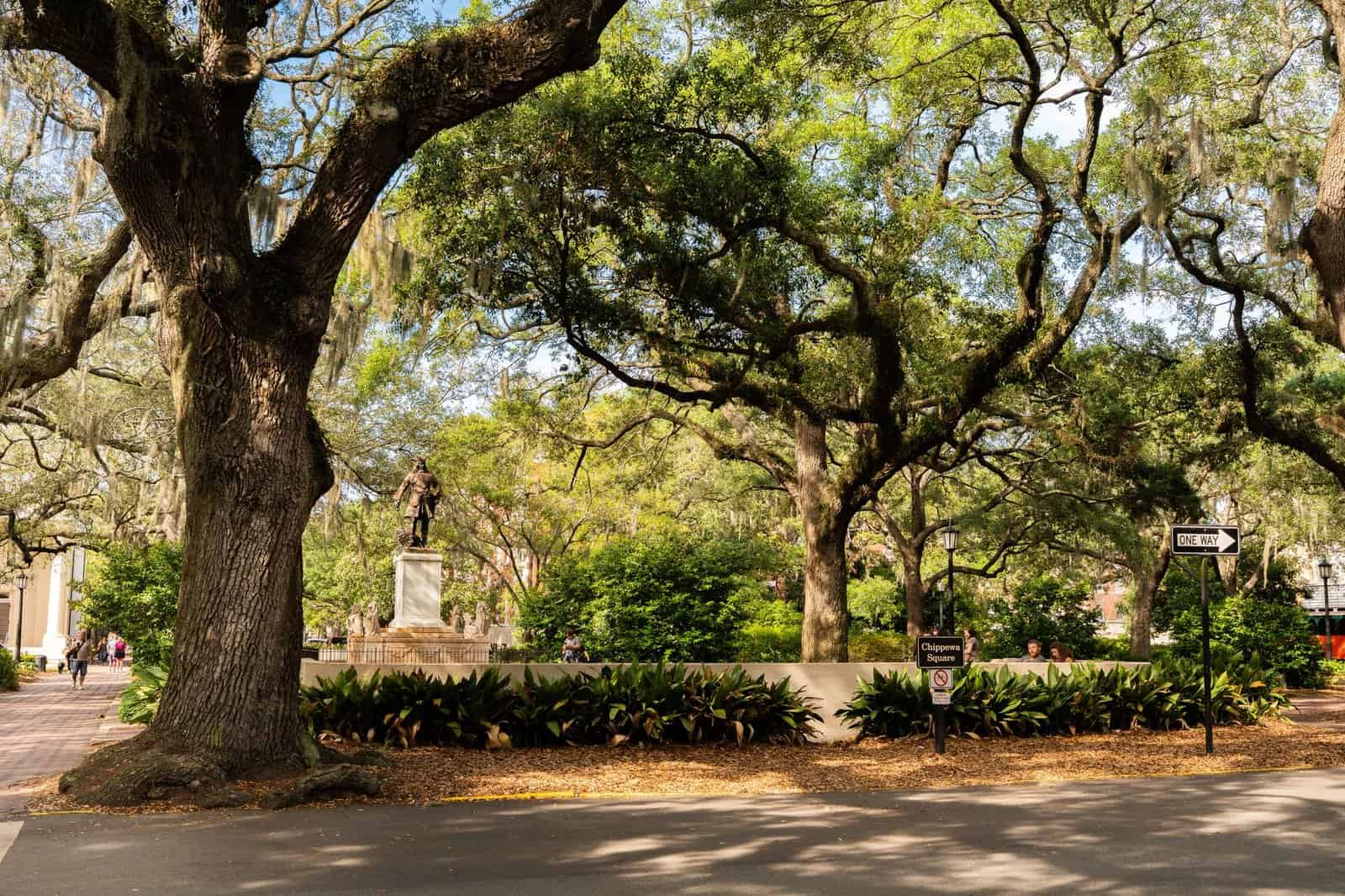 View of Chippewa Square in Savannah featuring lush live oaks and historical architecture.