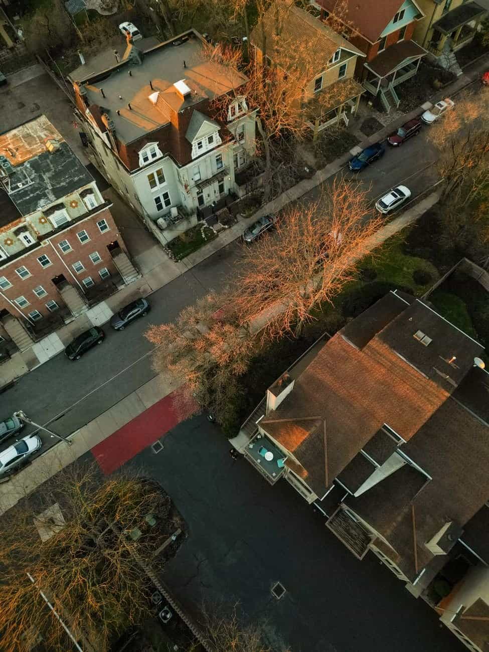 Aerial photograph capturing residential street in Cincinnati, Ohio during sunset, showcasing historic homes.