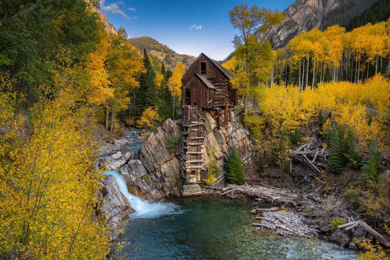 A picturesque view of the historic Crystal Mill surrounded by vibrant fall colors in Carbondale, Colorado.
