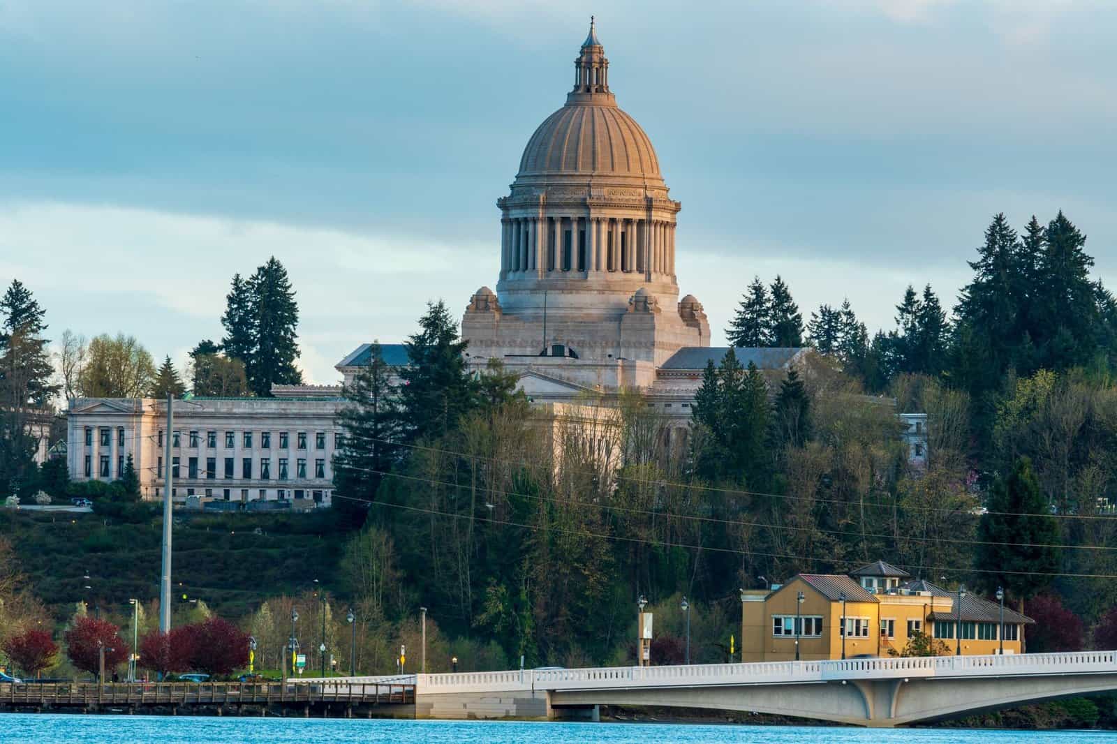 Scenic view of the Washington State Capitol building in Olympia surrounded by lush greenery.