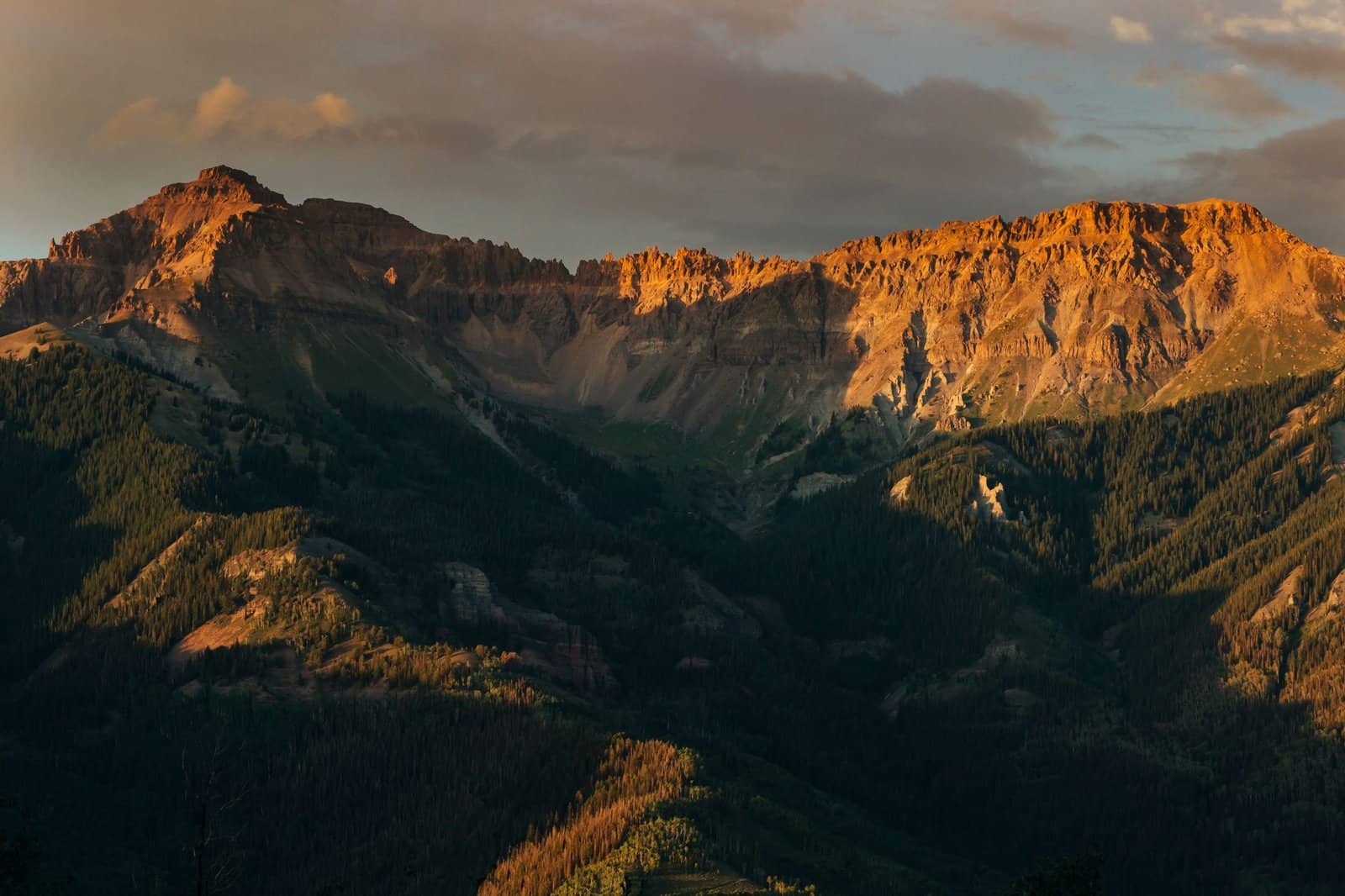 Stunning view of the Rocky Mountains during a warm sunset in Telluride, Colorado.