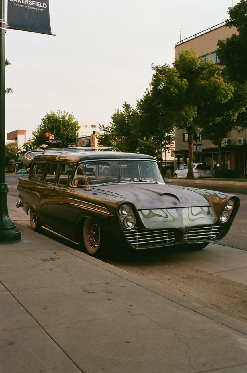 A retro car parked on an urban street, capturing a nostalgic vibe.