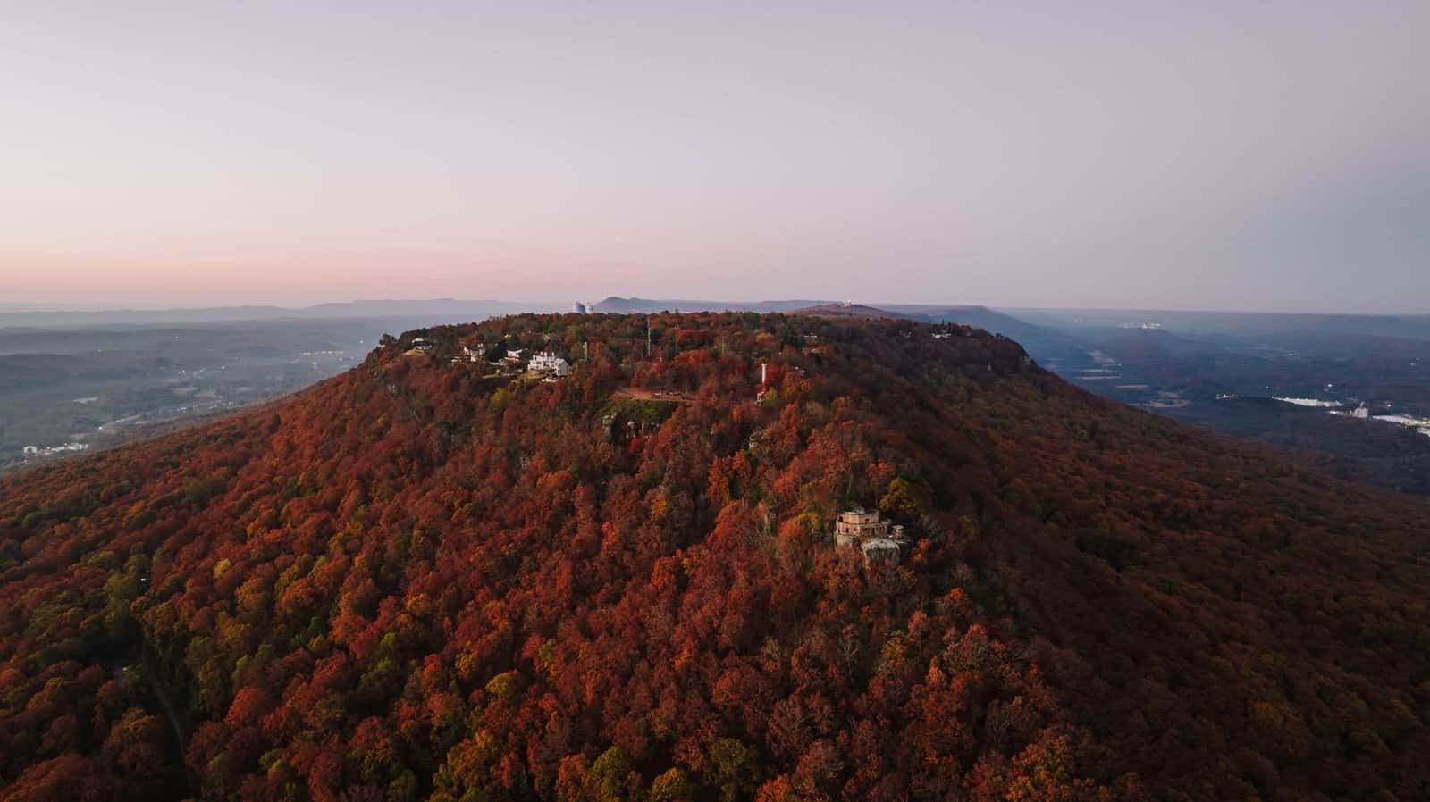 Breathtaking aerial capture of Lookout Mountain blanketed in vibrant fall foliage at dawn.