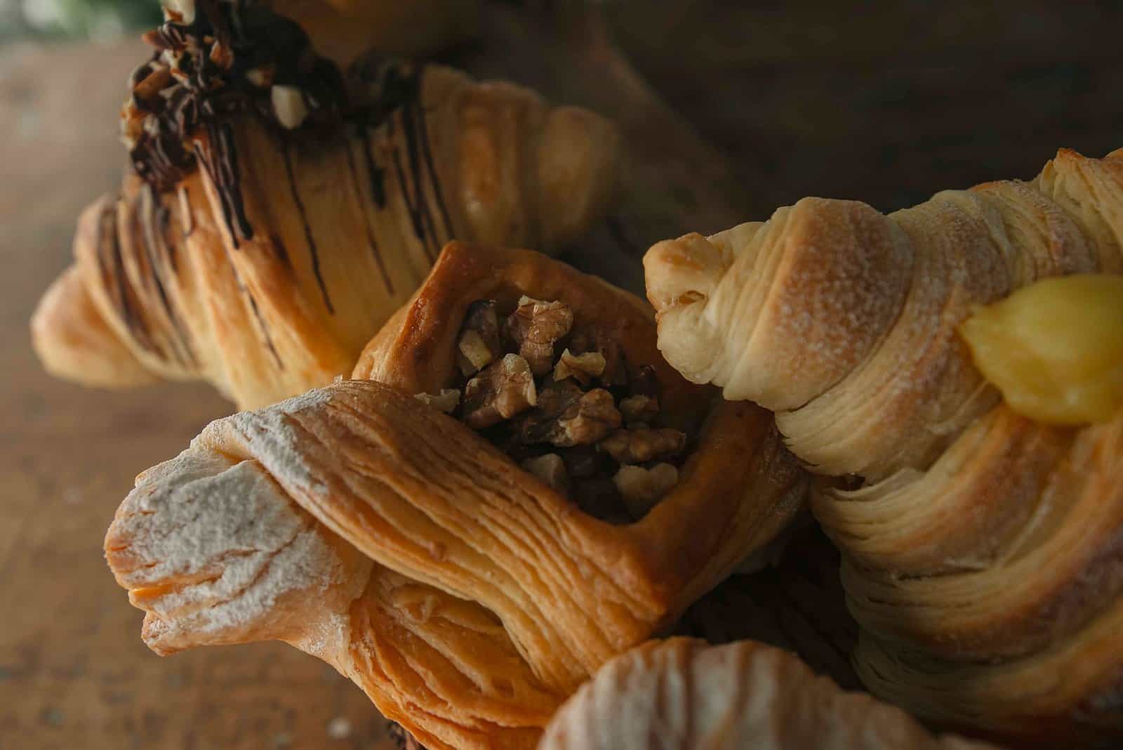 Delicious assortment of flaky pastries including croissants and nut-filled danish.